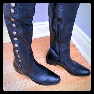 Over the knee tall black leather boots.